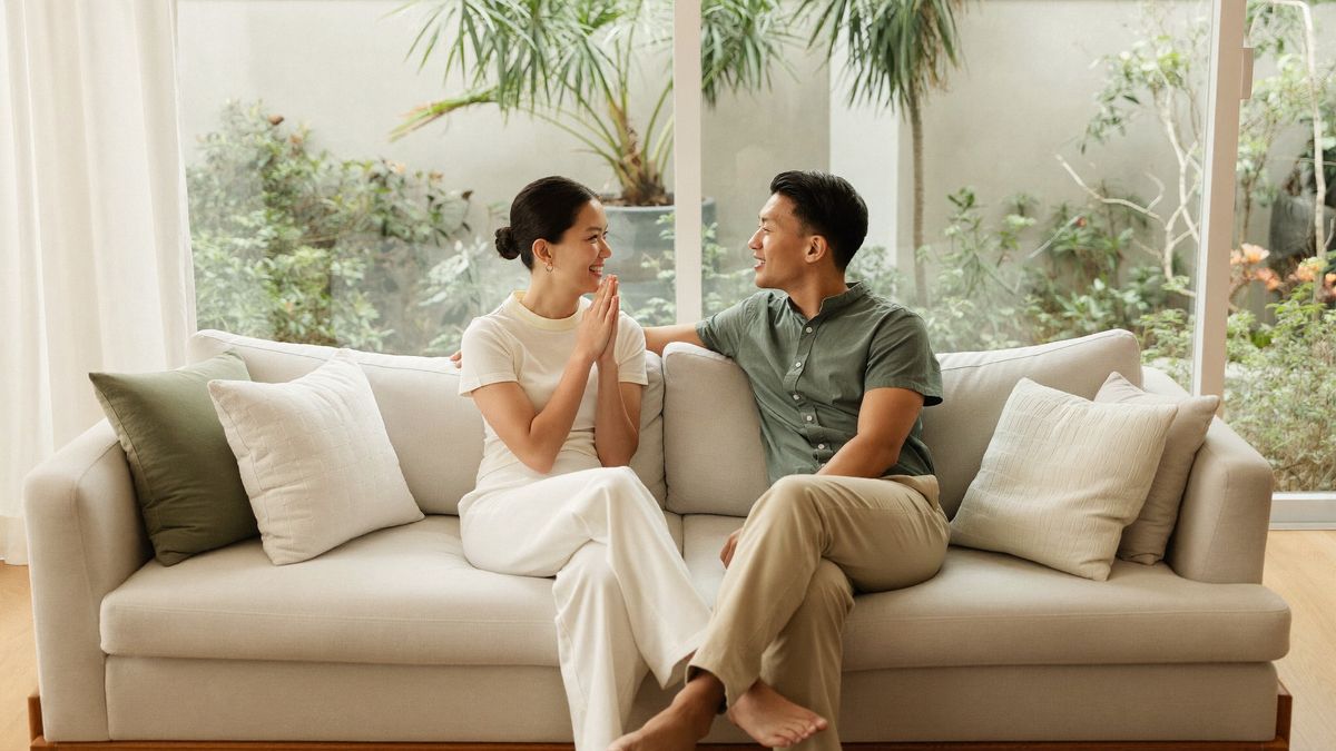 A couple in conversation in a bright living room